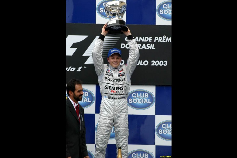 Kimi Raikkonen, McLaren, celebrates victory. Brazilian Grand Prix. Interlagos, Sao Paulo, April 6th 2003.