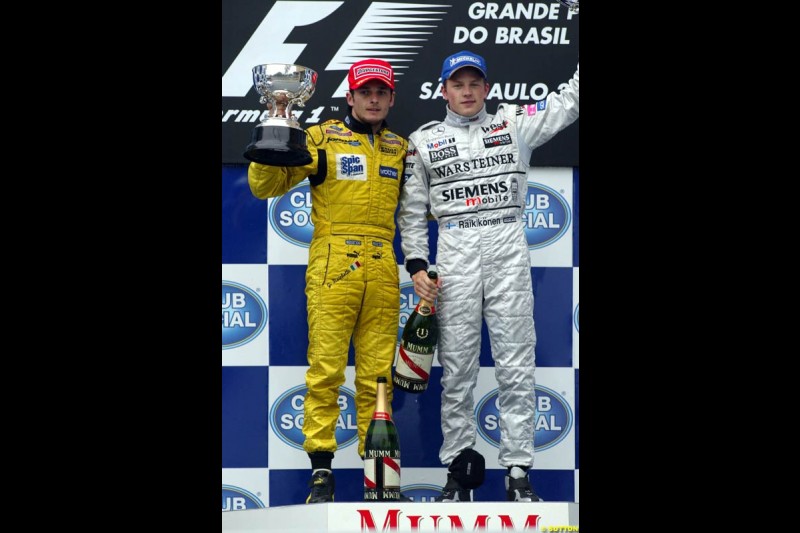 Kimi Raikkonen, McLaren, 1st, celebrates with Giancarlo Fisichella, Jordan, 2nd. Absent is Fernando Alonso, Renault, who required post race medical attention. Brazilian Grand Prix. Interlagos, Sao Paulo, April 6th 2003.