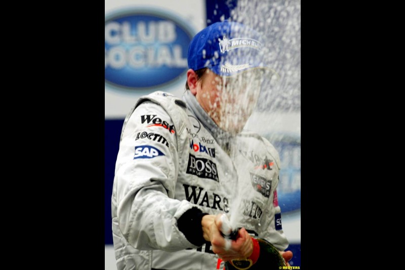 Kimi Raikkonen, McLaren, celebrates his second victory in a row. Brazilian Grand Prix. Interlagos, Sao Paulo, April 6th 2003.