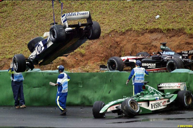 A collection of cars after turn 3 caught many drivers out due to wet conditions. Brazilian Grand Prix. Interlagos, Sao Paulo, April 6th 2003.