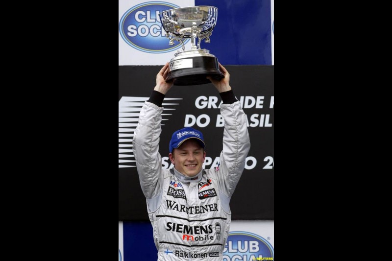 Kimi Raikkonen, McLaren, celebrates victory. Brazilian Grand Prix. Interlagos, Sao Paulo, April 6th 2003.