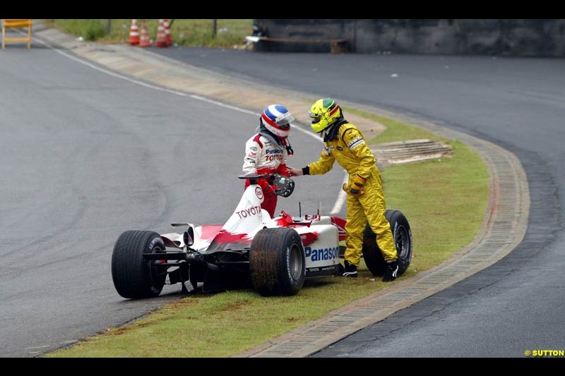 Olivier Panis, Toyota, and Ralph Firman, Jordan, discuss their accident. Brazilian Grand Prix. Interlagos, Sao Paulo, April 6th 2003.