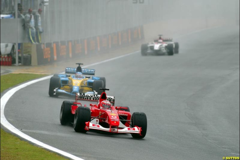 Rubens Barrichello, Ferrari, leads Jarno Trulli, Renault. Brazilian Grand Prix. Interlagos, Sao Paulo, April 6th 2003.