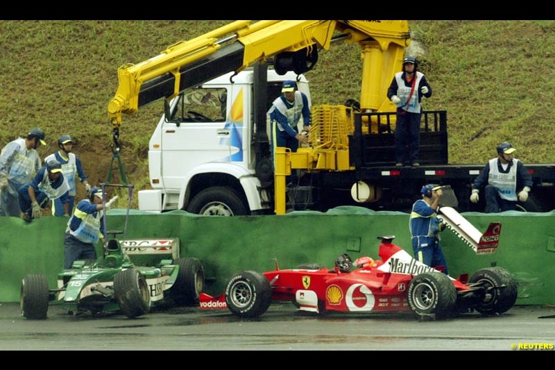 A collection of cars sits on the exit of turn 3 after wet conditions caught several drivers out. Brazilian Grand Prix. Interlagos, Sao Paulo, April 6th 2003.