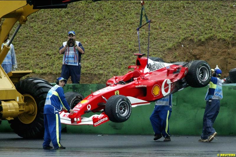 Michael Schumachers Ferrari is lifted from the circuit after the German crashed out of the Brazilian Grand Prix. Interlagos, Sao Paulo, April 6th 2003.