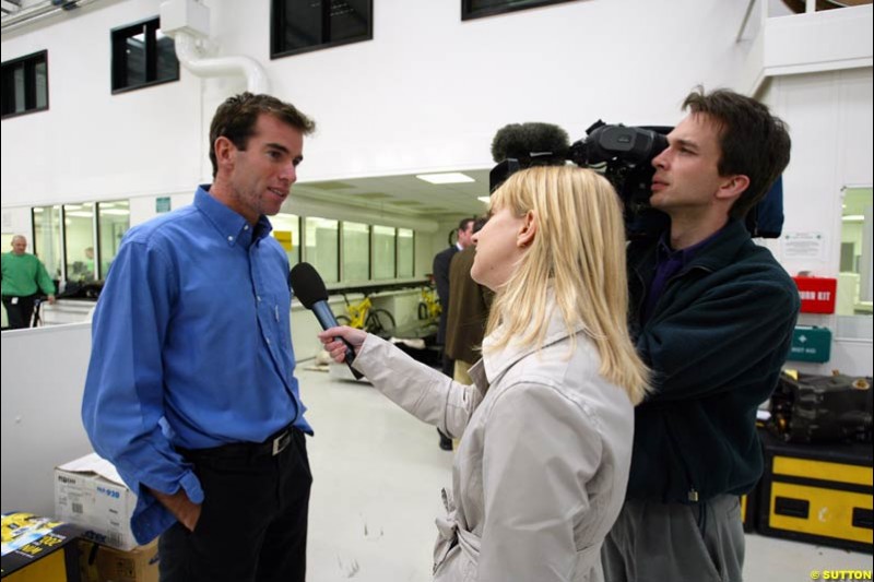 Ralph Firman is interviewed as Jordan celebrate Giancarlo Fisichella's belated victory at the Brazilian Grand Prix. 11 April, 2003.