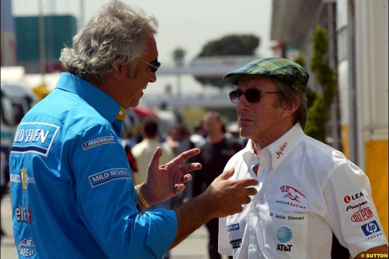 Flavio Briatore and Jackie Stewart. Friday, Spanish Grand Prix at the Circuit de Catalunya. Barcelona, Spain. May 2nd 2003.