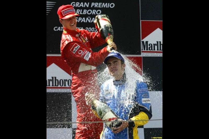 Michael Schumacher, Ferrari, celebrates victory with Fernando Alonso, Renault. Spanish Grand Prix. Circuit de Catalunya, Barcelona, Spain. May 4th 2003.