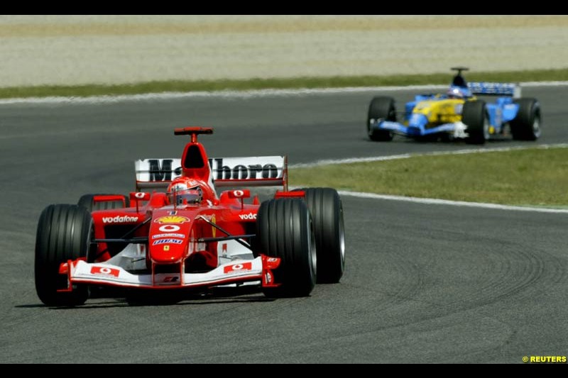 Michael Schumacher, Ferrari, leads Fernando Alonso, Renault. Spanish Grand Prix. Circuit de Catalunya, Barcelona, Spain. May 4th 2003.
