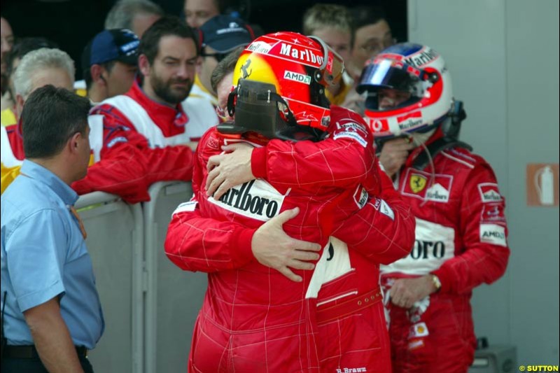 Ross Brawn, Ferrari Technical Director, hugs race winner Michael Schumacher, Ferrari. Spanish Grand Prix. Circuit de Catalunya, Barcelona, Spain. May 4th 2003.
