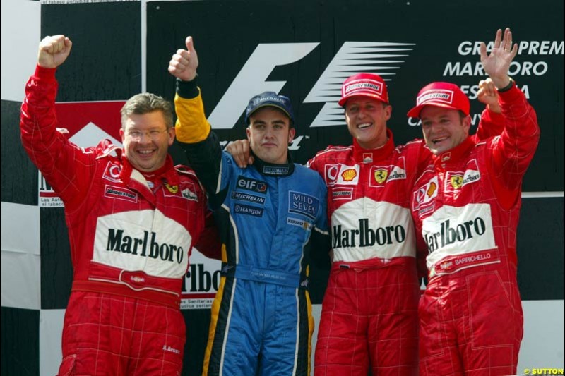 Ross Brawn, Ferrari Technical Director, Fernando Alonso, Renault (2nd), Michael Schumacher, Ferrari (1st), Rubens Barrichello, Ferrari (3rd), make up the podium. Spanish Grand Prix. Circuit de Catalunya, Barcelona, Spain. May 4th 2003.