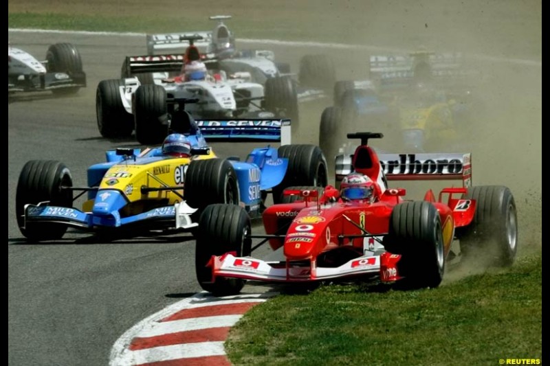 Rubens Barrichello, Ferrari, is forced wide at turn one. Spanish Grand Prix. Circuit de Catalunya, Barcelona, Spain. May 4th 2003.