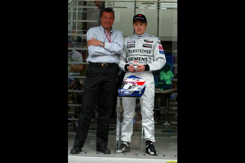 Jean-Christophe Babin, TAG Heuer CEO, presents a special edition engraved watch to Kimi Raikkonen, McLaren, to celebrate his first GP win in Malaysia. Sunday, Spanish Grand Prix, Circuit de Catalunya. Barcelona, Spain, May 4th 2003.