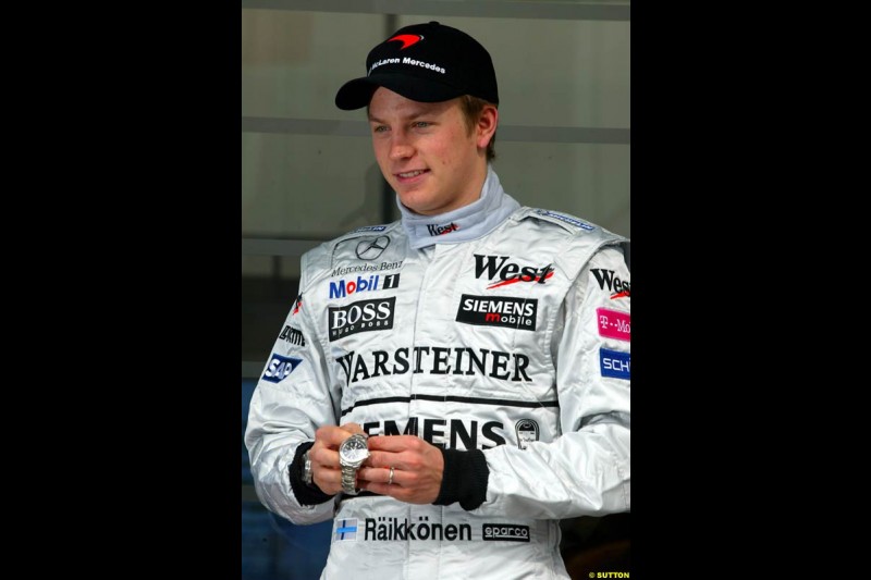 Jean-Christophe Babin, TAG Heuer CEO, presents a special edition engraved watch to Kimi Raikkonen, McLaren, to celebrate his first GP win in Malaysia. Sunday, Spanish Grand Prix, Circuit de Catalunya. Barcelona, Spain, May 4th 2003.