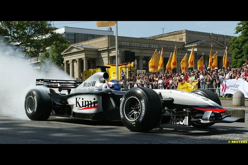 Kimi Raikkonen drives his McLaren Mercedes in Stuttgart's inner city to present his F1 car at the 100th anniversary of the General German Automobile Association (ADAC). May 24, 2003.