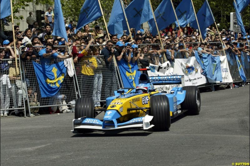 Renault's Fernando Alonso speeds down Madrid's central Paseo de la Castellana during an exhibition celebrating his success so far this season. May 11th 2003.
