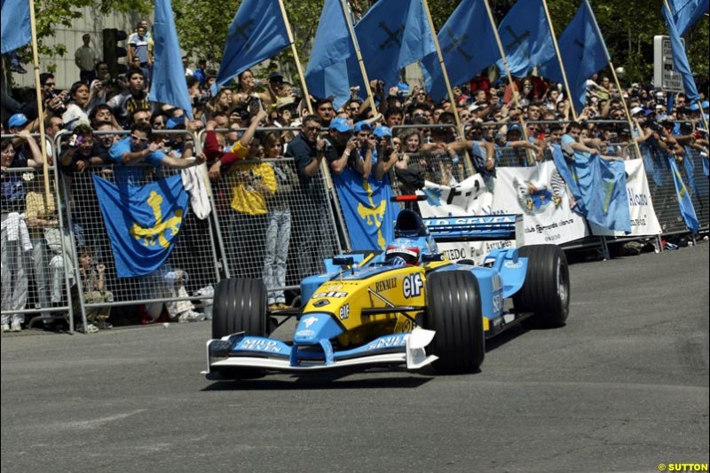 Renault's Fernando Alonso speeds down Madrid's central Paseo de la Castellana during an exhibition celebrating his success so far this season. May 11th 2003. 