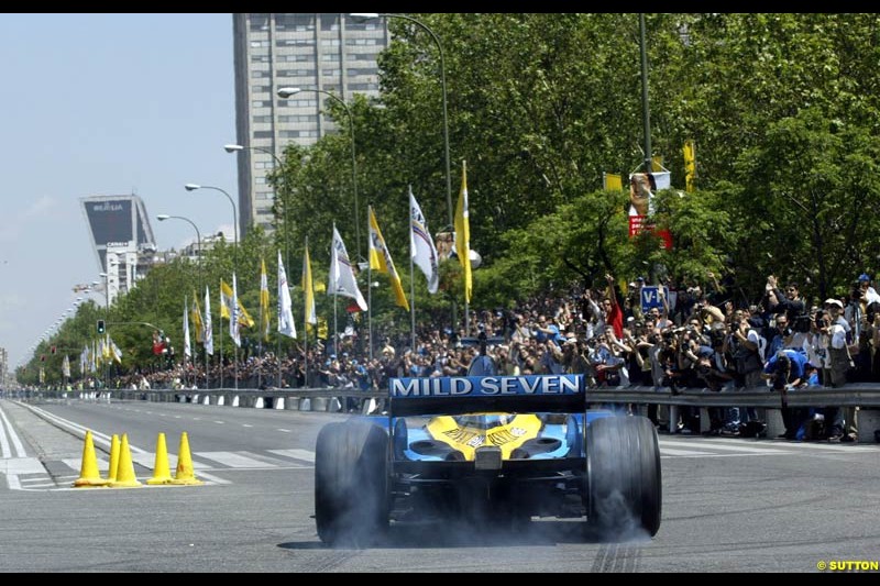 Renault's Fernando Alonso speeds down Madrid's central Paseo de la Castellana during an exhibition celebrating his success so far this season. May 11th 2003.