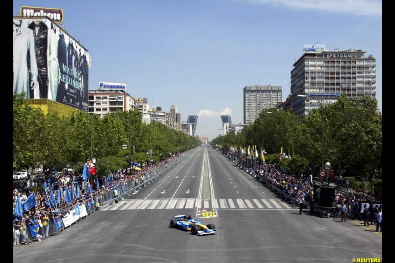 Renault's Fernando Alonso speeds down Madrid's central Paseo de la Castellana during an exhibition celebrating his success so far this season. May 11th 2003.
