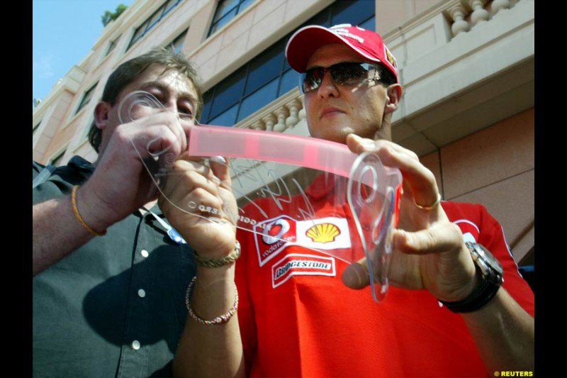 Michael Schumacher, Ferrari, signs autographs. Wednesday, Monaco Grand Prix, Monte Carlo. May 28th 2003.