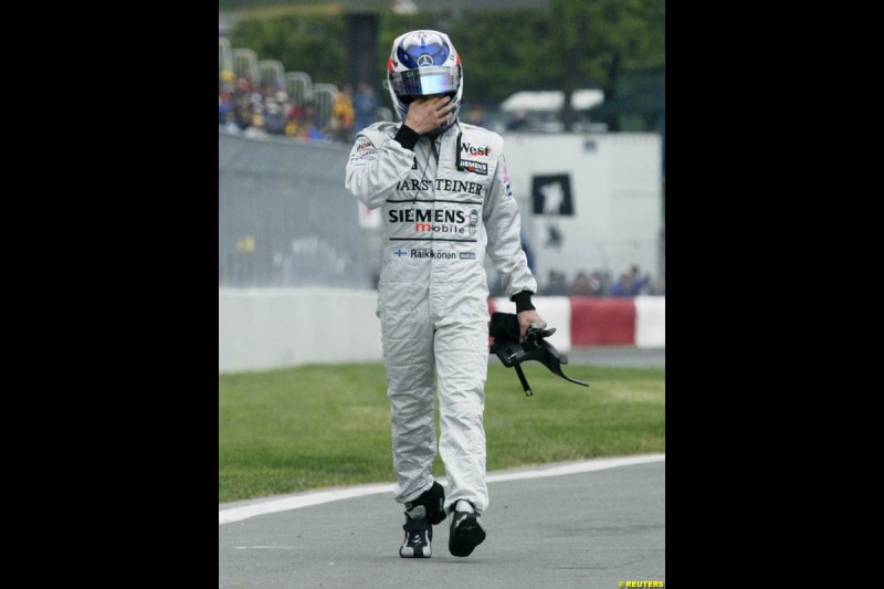 Kimi Raikkonen, McLaren, walks back to the pits. Canadian Grand Prix, Montreal, Saturday, June 14th 2003.