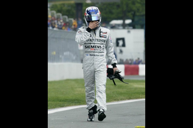 Kimi Raikkonen, McLaren, walks back to the pits. Canadian Grand Prix, Montreal, Saturday, June 14th 2003.
