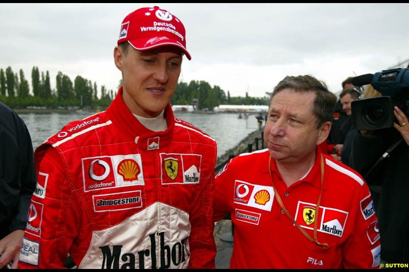 Jean Todt, Ferrari General Manager, chats to Michael Schumacher, Ferrari. Canadian Grand Prix, Montreal, Saturday, June 14th 2003.