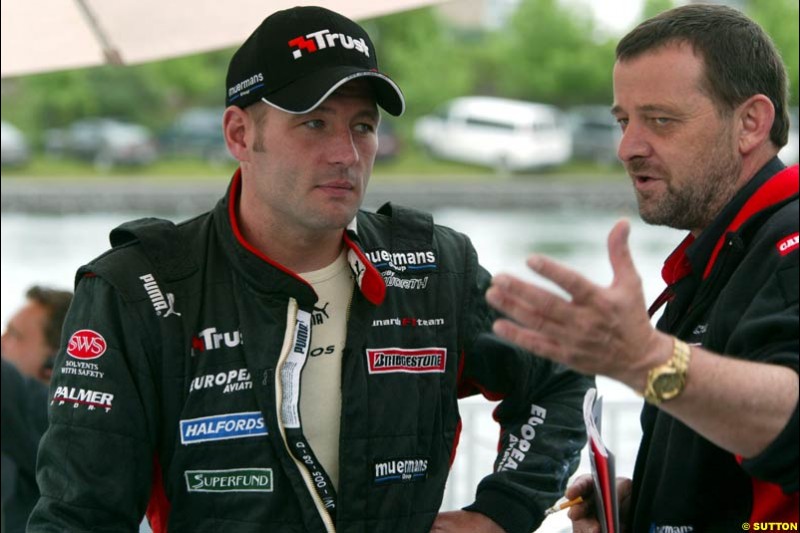 Paul Stoddart, Minardi Team Principal, chats to Jos Verstappen, Minardi. Canadian Grand Prix, Montreal, Saturday, June 14th 2003.