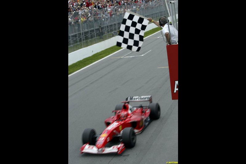 Michael Schumacher, Ferrari, crosses the line to take victory. Canadian Grand Prix, Montreal, Sunday, June 15th 2003.