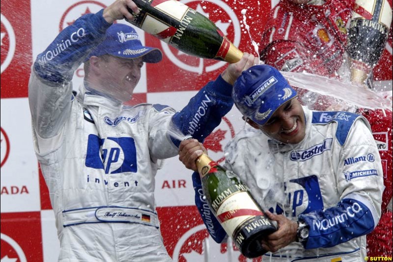 Ralf Schumacher, Williams, soaks team mate Juan Pablo Montoya, Williams, in champagne. Canadian Grand Prix, Montreal, Sunday, June 15th 2003.
