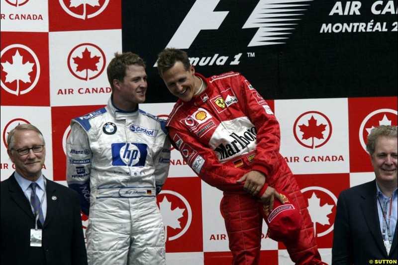 Michael Schumacher, Ferrari, 1st, chats with Ralf Schumacher, Williams, 2nd. Canadian Grand Prix, Montreal, Sunday, June 15th 2003. 
