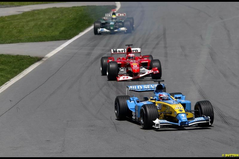 Fernando Alonso, Renault, leads Rubens Barrichello, Ferrari. Canadian Grand Prix, Montreal, Sunday, June 15th 2003.