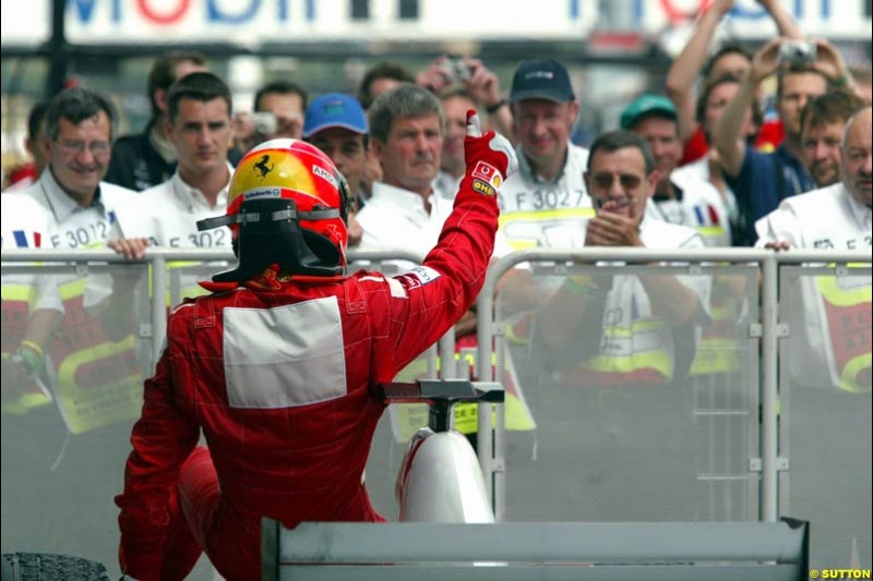 Michael Schumacher, Ferrari, celebrates third place. French Grand Prix at Magny Cours. Circuit de Nevers, France. Sunday, July 6th 2003.