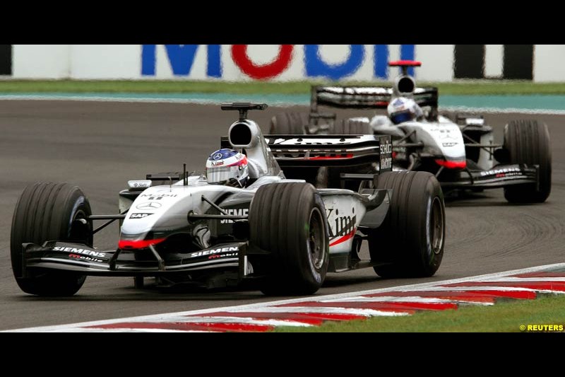 Kimi Raikkonen, McLaren, leads team mate David Coulthard. French Grand Prix at Magny Cours. Circuit de Nevers, France. Sunday, July 6th 2003.