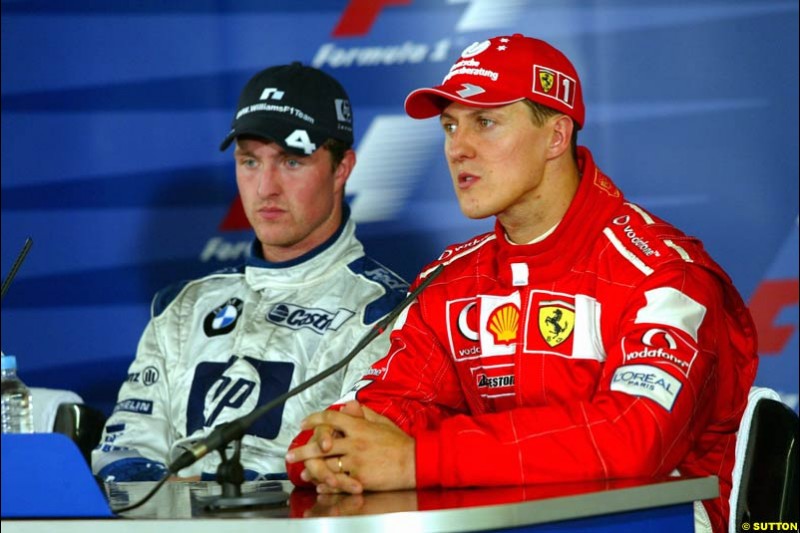 Michael Schumacher, Ferrari, along side brother Ralf Schumacher, Williams. French Grand Prix at Magny Cours. Circuit de Nevers, France. Sunday, July 6th 2003.