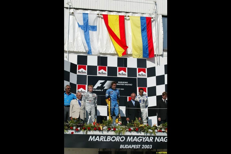 The podium. 1st, Fernando Alonso, Renault; 2nd, Kimi Raikkonen, McLaren; 3rd, Juan Pablo Montoya, Williams. Hungarian Grand Prix Sunday. Hungaroring, Budapest. 24th August, 2003.