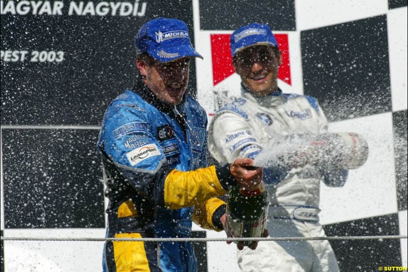 Fernando Alonso, Renault, celebrates on the podium. Hungarian Grand Prix Sunday. Hungaroring, Budapest. 24th August, 2003.