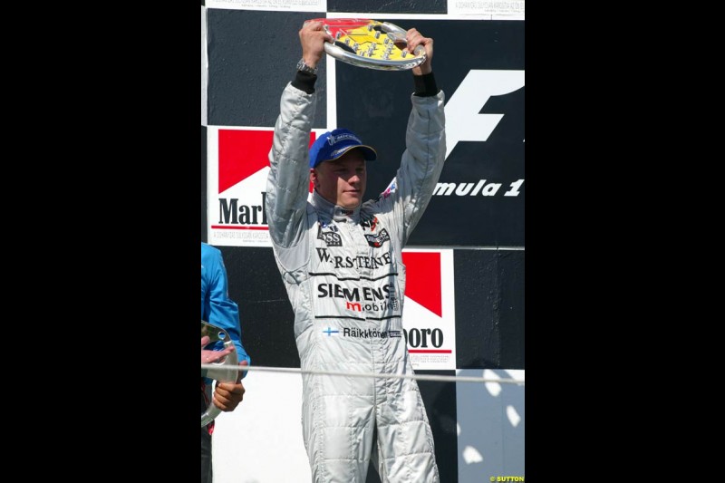 Kimi Raikkonen, McLaren, celebrates on the podium. Hungarian Grand Prix Sunday. Hungaroring, Budapest. 24th August, 2003.