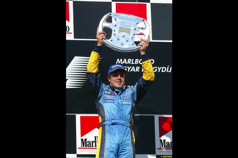 Fernando Alonso, Renault, celebrates on the podium. Hungarian Grand Prix Sunday. Hungaroring, Budapest. 24th August, 2003.