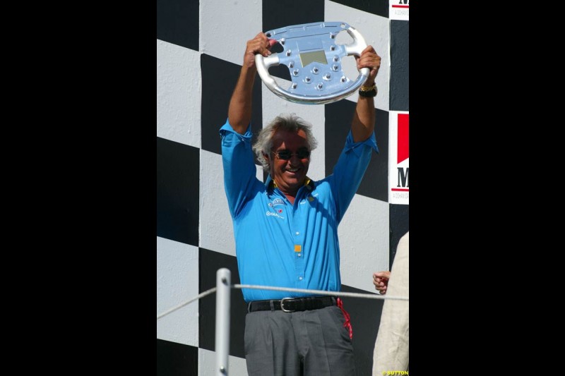 Flavio Briatore, Renault Team Principle, celebrates on the podium. Hungarian Grand Prix Sunday. Hungaroring, Budapest. 24th August, 2003.