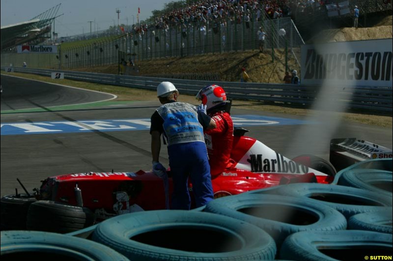 Rubens Barrichello, Ferrari, steps out of his car after crashing out. Hungarian Grand Prix Sunday. Hungaroring, Budapest. 24th August, 2003.