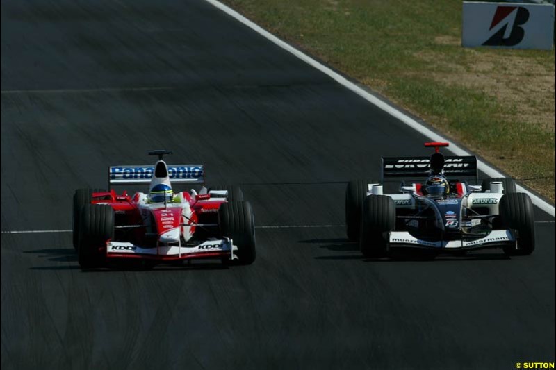 Cristiano Da Matta, Toyota, passes Nicolas Kiesa, Minardi. Hungarian Grand Prix Sunday. Hungaroring, Budapest. 24th August, 2003.