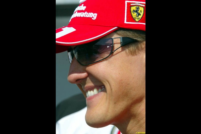 Michael Schumacher, Ferrari, looks on the bright side of 8th place on the grid. Hungarian Grand Prix Sunday. Hungaroring, Budapest. 24th August, 2003.