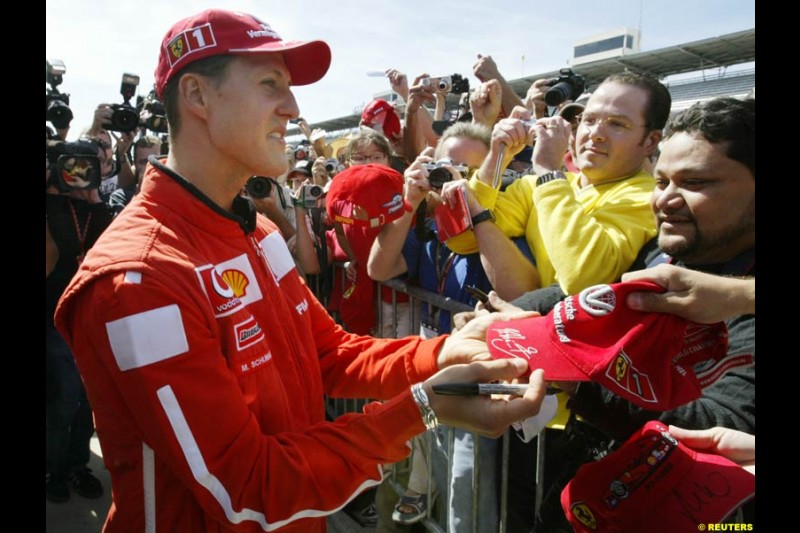 Ferrari's Michael Schumacher with the fans. United States GP, Indianapolis Motor Speeway. Thursday, September 25th 2003.