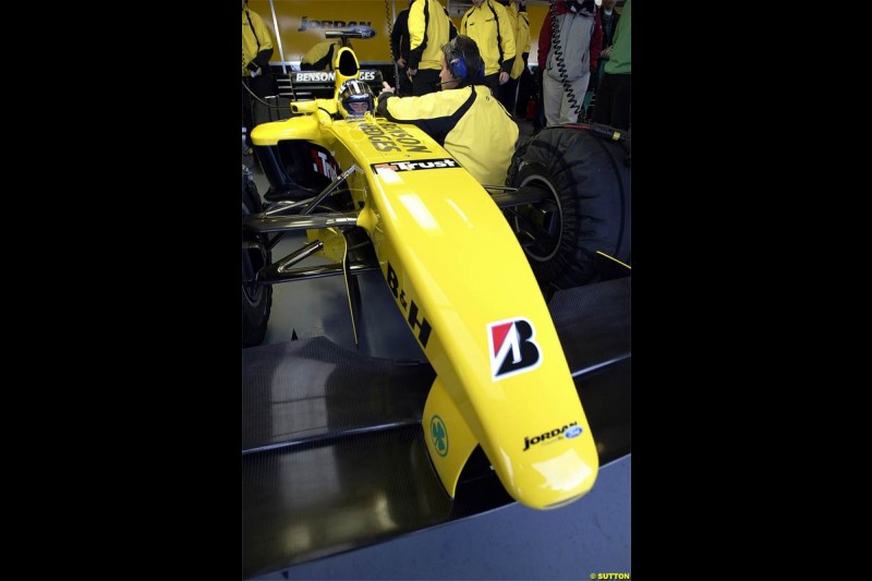 Nick Heidfeld waits to test the new Jordan EJ14 at Silverstone. February 2 2004. 