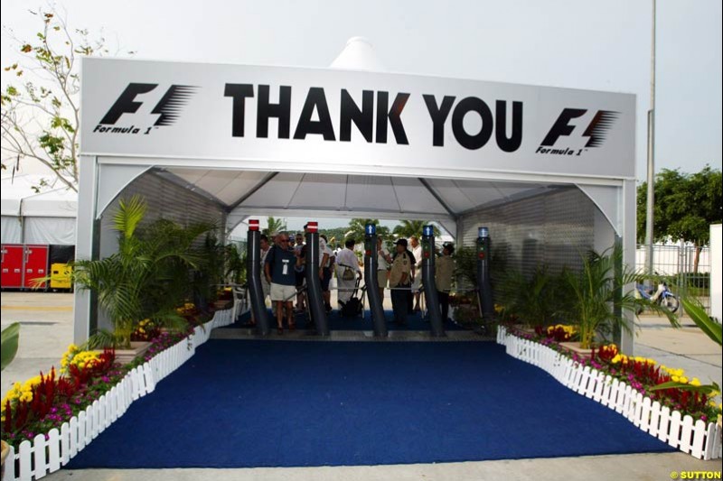 The Sepang paddock exit. Saturday qualifying for the Malaysian Grand Prix. Sepang, Kuala Lumpur, Malaysia. March 20th 2004.