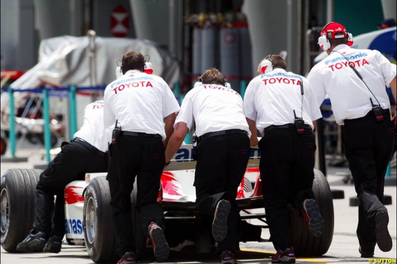 A Toyota TF104 is pushed down the pitlane Saturday qualifying for the Malaysian Grand Prix. Sepang, Kuala Lumpur, Malaysia. March 20th 2004.