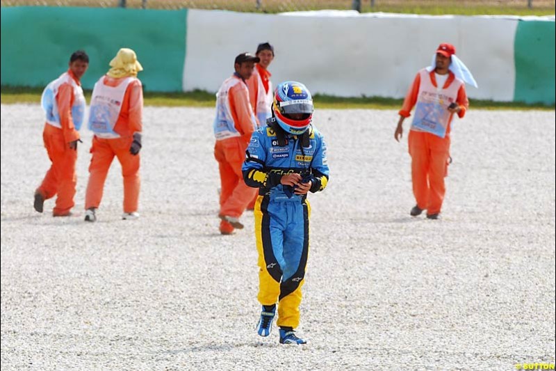 Fernando Alonso walks away after spinning. Saturday qualifying for the Malaysian Grand Prix. Sepang, Kuala Lumpur, Malaysia. March 20th 2004.