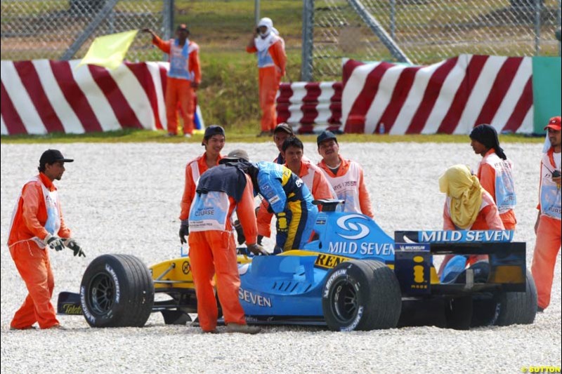 Fernando Alonso's Renault toed away, after the Spaniard spun off on his flying lap. Saturday qualifying for the Malaysian Grand Prix. Sepang, Kuala Lumpur, Malaysia. March 20th 2004.