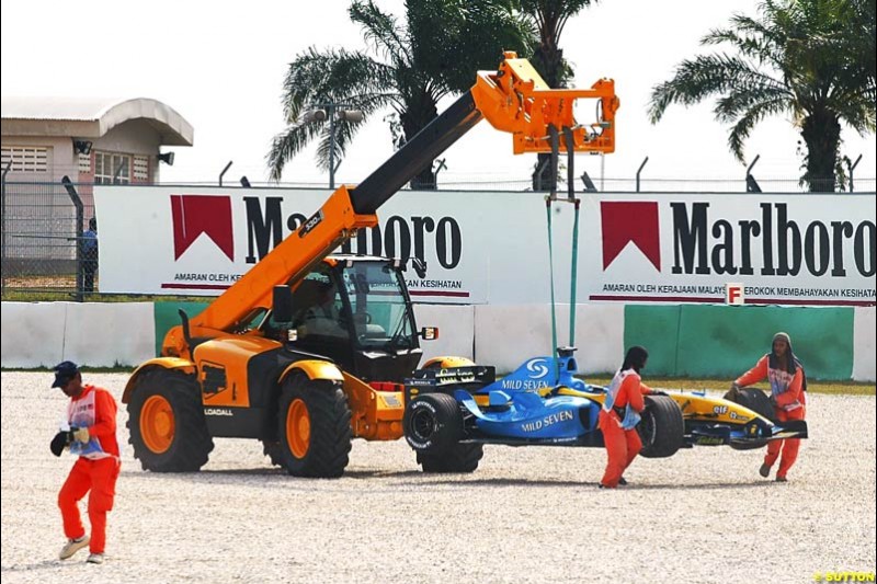 Fernando Alonso's Renault toed away, after the Spaniard spun off on his flying lap. Saturday qualifying for the Malaysian Grand Prix. Sepang, Kuala Lumpur, Malaysia. March 20th 2004.